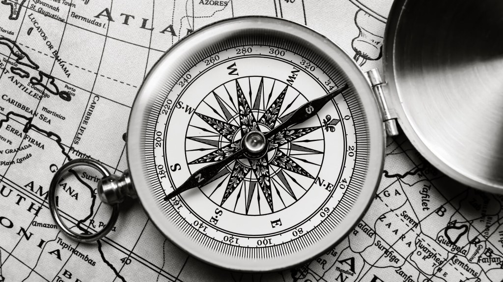 Compass resting on an old map