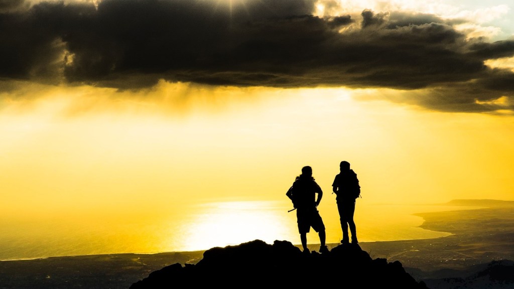 Two climbers standing on the summit